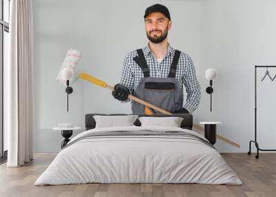 Young worker making repair in room. Wall mural