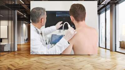 Man and doctor looking at screen, doing ultrasound check up Wall mural