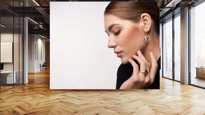 Model demonstrating earrings and ring. Wall mural