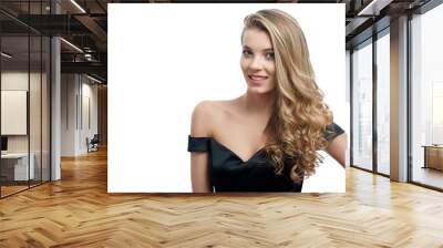 Portrait of a beatiful smiling girl with blonde curly hair in a nice evening dress with an open top. Photo was made on the white studio background. She looks gorgeous Wall mural