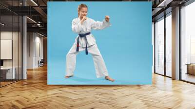 Side view of girl doing martial arts on isolated background Wall mural