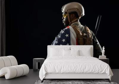 Soldier holding modern weapon and American flag on shoulder. Wall mural