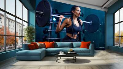 Woman doing bulgarian squats using barbell in gym. Wall mural