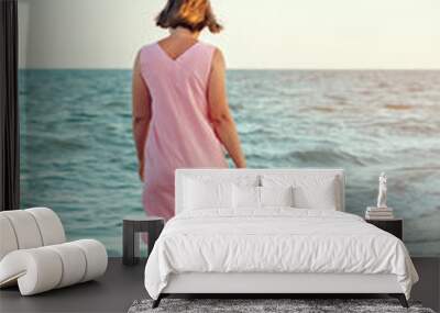 girl walking in the beach during sunset Wall mural