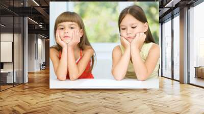 Portrait of two sad little girls Wall mural