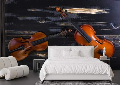 two violins on a black wooden background Wall mural