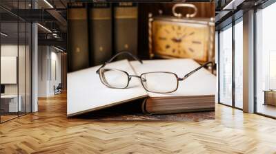 The glasses lie on the open book in the library Wall mural