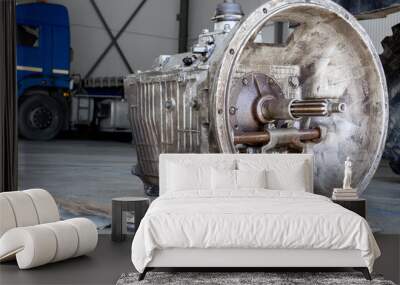 A disassembled industrial truck transmission awaiting repair or recycling, placed on a wooden pallet in a workshop Wall mural