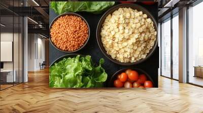 A vibrant arrangement of fresh ingredients features leafy greens, cherry tomatoes, and cooked grains. This colorful display showcases healthy choices ideal for meal preparation or recipe inspiration i Wall mural