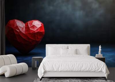 The image features a striking red heart made from geometric shapes, sitting on a textured blue surface. The dark background adds depth, creating a dramatic effect that enhances the hearts vibrant colo Wall mural