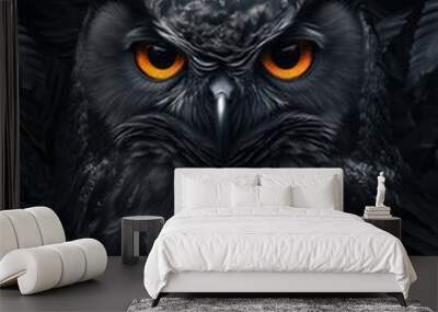 Black owl against the background of black plant leaves. Wall mural