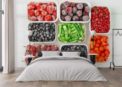 Top view frozen vegetables and berries in plastic containers Wall mural