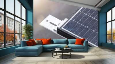 Bracket for mounting solar panels. Mounting a solar panel close-up on the roof of a residential building, water drops after rain, green energy production. Wall mural