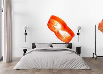 Set of slices of red pepper drops on a white background. Paprika flying in air on isolated white background Wall mural