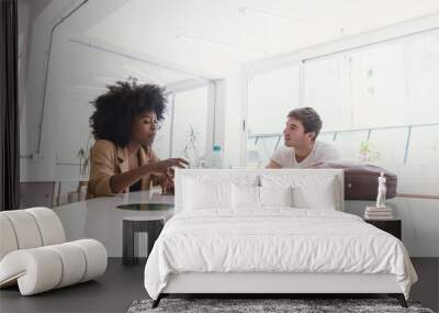 Black Latina Girl With Afro And Latino Caucasian Boy Sitting talking Wall mural