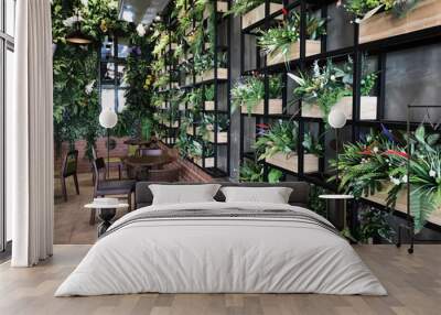 Artificial plant decoration on the wall of coffee cafe interior. Wall mural