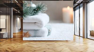 Fresh white towels with fir branch, candles and Christmas decorations. Wellness and wellbeing. SPA massage or beauty salon, relaxation and self care in Christmas or New Year variant. Copy space. Wall mural