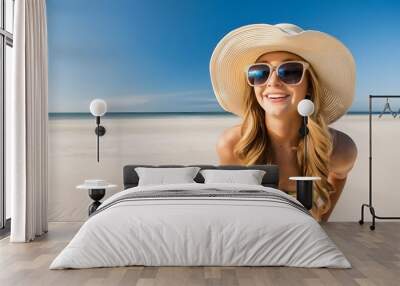 Portrait of an influencer smiling young woman on a tropical beach wearing sunglasses and straw hat blue background  Wall mural