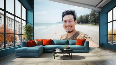 Cheerful and happy face of man selfie himself on the beach. Wall mural