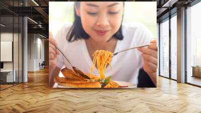 Close up of woman eats spaghetti. Wall mural