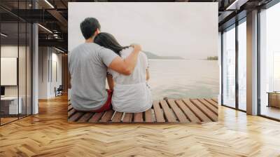 Lover couple hold together and admire the romantic beautiful lake landscape. Wall mural