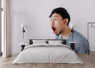 Shocked and surprised face of Asian man in isolated on white background. Wall mural