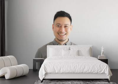 smile happy face of ordinary man in grey shirt. concept of charming and positive thinking. Wall mural