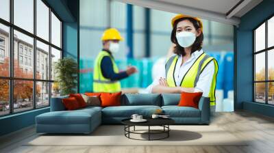 Chief industrial engineer inspects the mask factory. portrait woman while using a laptop. They show an assertive demeanor. Protective equipment in the danger zone. Wall mural