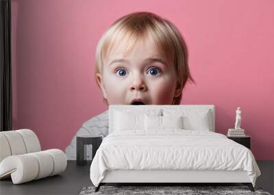 Toddler white boy with chubby cheeks and straight blonde hair crying soft red background Wall mural