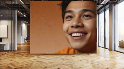 young filipino teenage boy on plain bright orange background laughing hysterically looking at camera background banner template ad marketing concept from Generative AI Wall mural