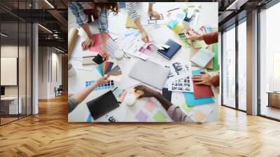 Above view closeup of creative business team brainstorming design ideas over table, copy space Wall mural