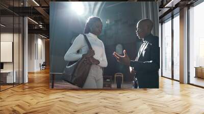 African woman talking to priest after ceremony in the church Wall mural