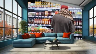 Back view of unrecognizable old man shopping in supermarket and buying groceries, copy space Wall mural