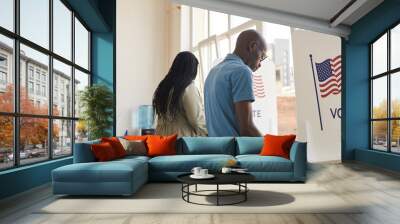 Back view portrait of young African-American people standing in voting booth and thinking, copy space Wall mural