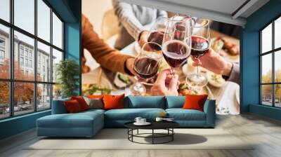 Close up of people toasting with red wine glasses at festive dinner table, copy space Wall mural