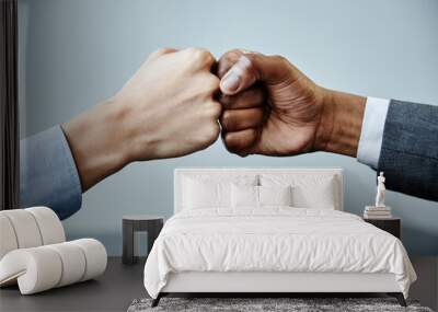 Close up of two business partners fistbumping in unity at meeting table, copy space Wall mural