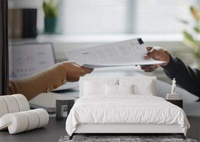 Close up of two hands handing document or contract over meeting table in office Wall mural