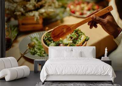 Close up of unrecognizable African-American man serving food while enjoying dinner with family Wall mural