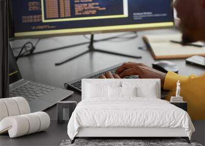 Close up of unrecognizable black man typing at keyboard while writing code in IT development company, copy space Wall mural