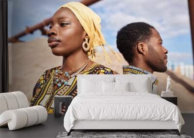 Close up portrait of traditional African American couple standing back to back in desert sun, focus on woman in foreground Wall mural