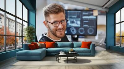 Close up portrait of young software developer smiling at camera and wearing glasses in office, copy space Wall mural