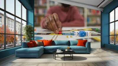 Closeup of black man playing board game with focus on male hand moving game piece, copy space Wall mural