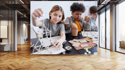 Diverse group of children making wooden models during art and craft class in school, copy space Wall mural