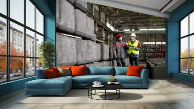 Full length portrait of two workers walking across workshop in modern industrial plant, copy space Wall mural