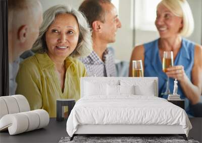 Group of modern senior people drinking champagne while enjoying party at home, copy space Wall mural