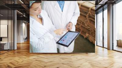 High angle portrait of  two factory workers using digital tablet while inspecting production at recycling plant, copy space Wall mural