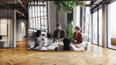 High angle view at diverse business team discussing project at meeting table focus on bearded man smiling at colleagues, copy space Wall mural