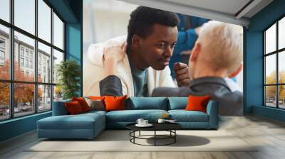 High angle view at young African-American man smiling gratefully to psychologist while while in support group circle, copy space Wall mural