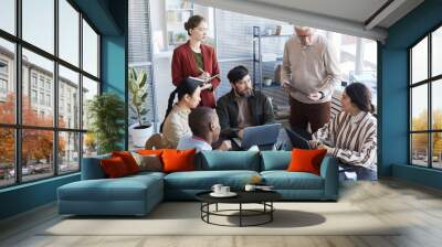 Large diverse group of business people planning project together while sitting at table during meeting in office Wall mural