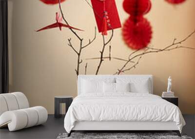 Minimal background image of tree branches decorated with paper cranes and red envelopes as Chinese New Year tradition Have overflowing abundance every year Wall mural